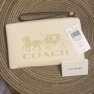 Cream Coach wristlet.